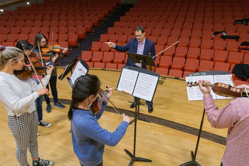 Guillaume Combet is an associate professor of violin for the School of Music in the College of Arts and Sciences. Photographed for the President's Report while teaching a group lesson in Loudis Recital Hall and an individual lesson.